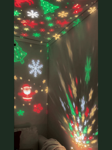Festive stars, snowflakes and Santa projections moving across a room
